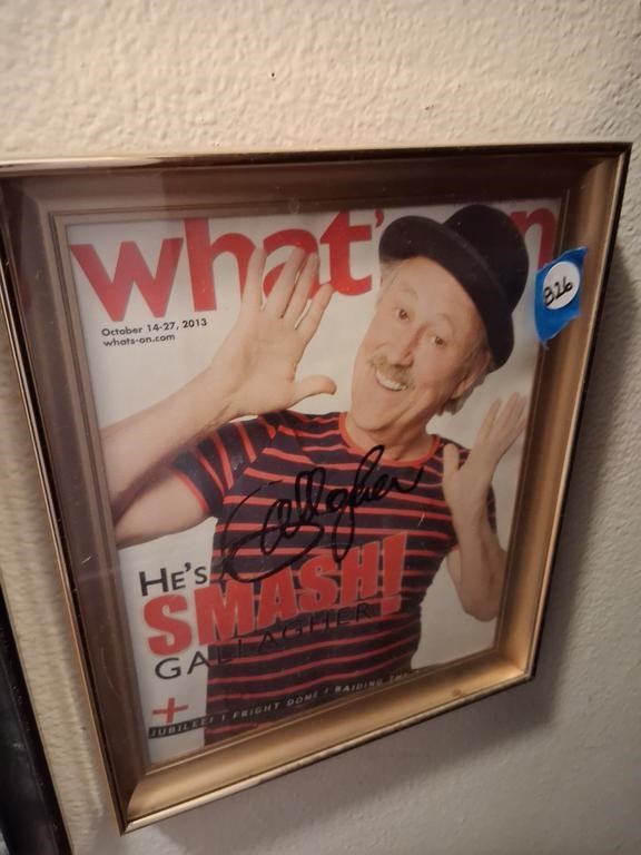 Auction Item Framed, autographed What’s On magazine cover titled “He’s Smash! Gallagher,” featuring the comedian smiling in a striped shirt and bowler hat.